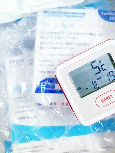 Digital thermometer in protective box highlighting sleek design and secure packaging for safe storage and transport.